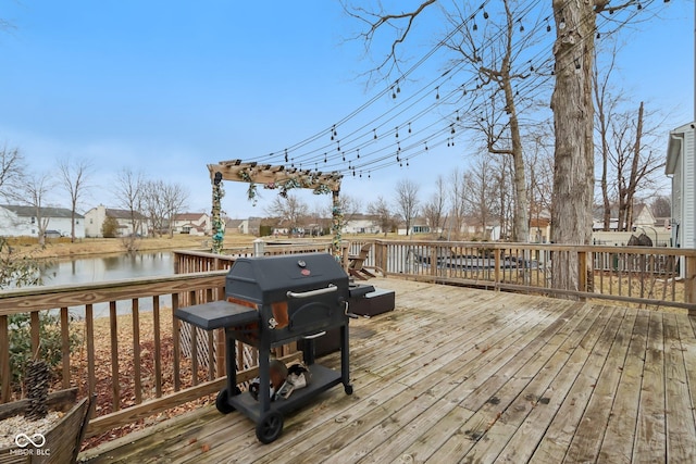 deck featuring a water view and area for grilling