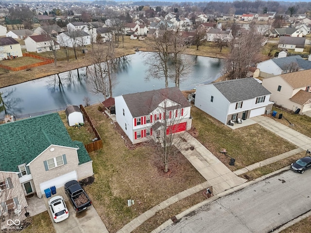 bird's eye view featuring a water view and a residential view