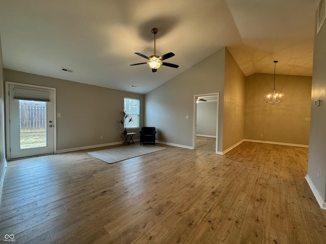 unfurnished living room with visible vents, baseboards, wood finished floors, and ceiling fan with notable chandelier