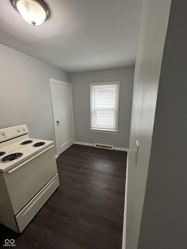 kitchen featuring white range with electric stovetop, visible vents, dark wood finished floors, and baseboards