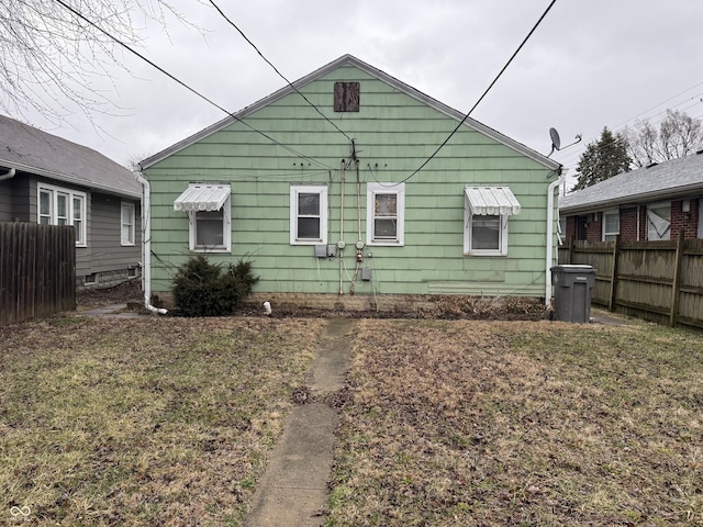 back of house with fence