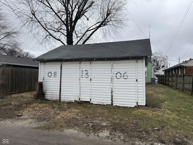 view of shed featuring fence