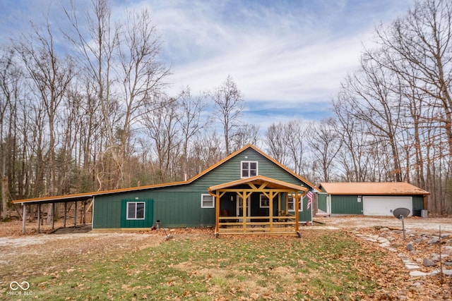 view of front facade with a garage and an outbuilding