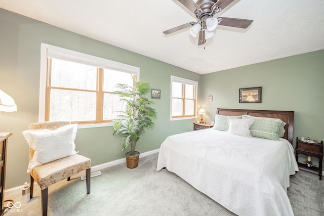 carpeted bedroom with visible vents, ceiling fan, and baseboards