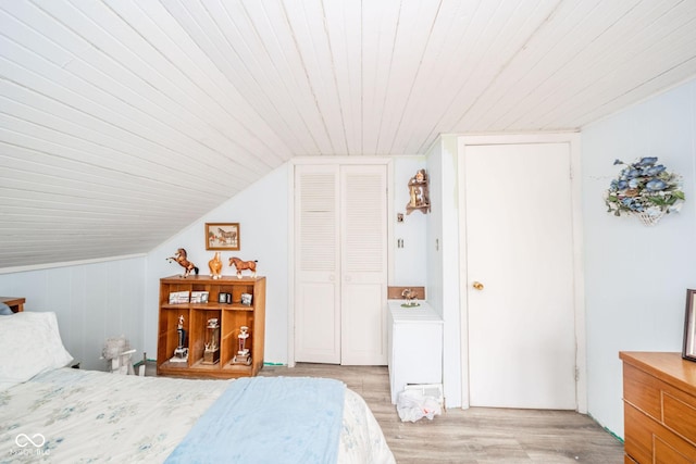 bedroom with light wood-style floors, lofted ceiling, and wood ceiling