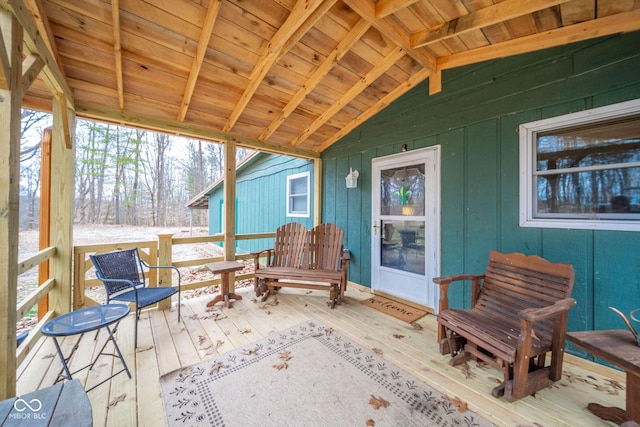 sunroom featuring vaulted ceiling with beams and wood ceiling