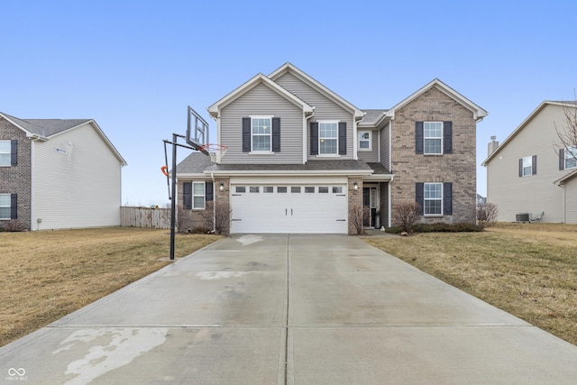 traditional home with a garage, concrete driveway, a front lawn, and brick siding