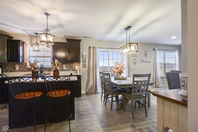 dining area with dark wood-type flooring and baseboards