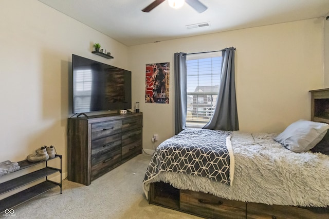 bedroom featuring light carpet, ceiling fan, and visible vents