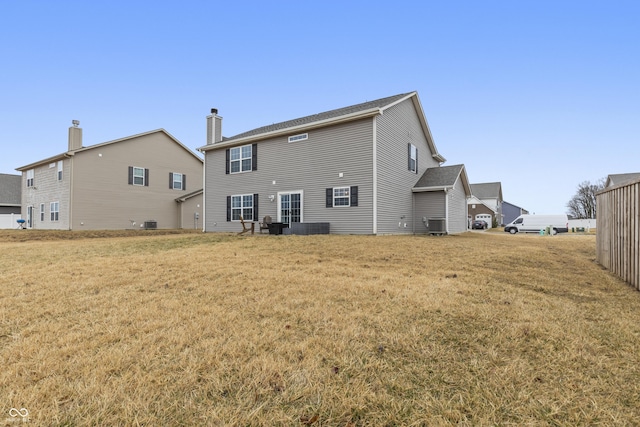 rear view of property with a lawn