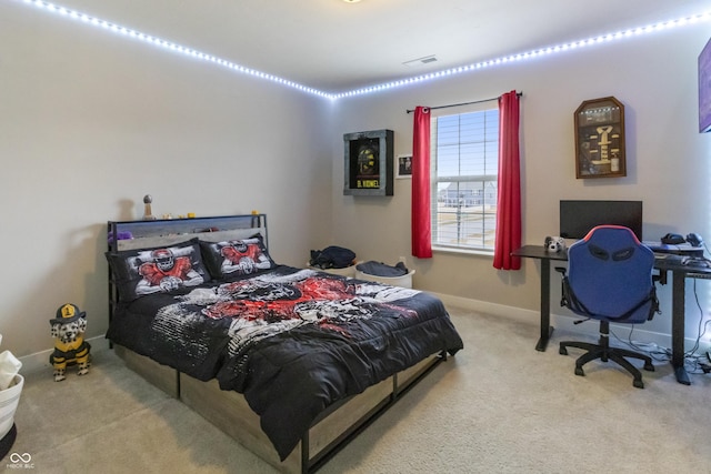 bedroom with carpet, visible vents, and baseboards