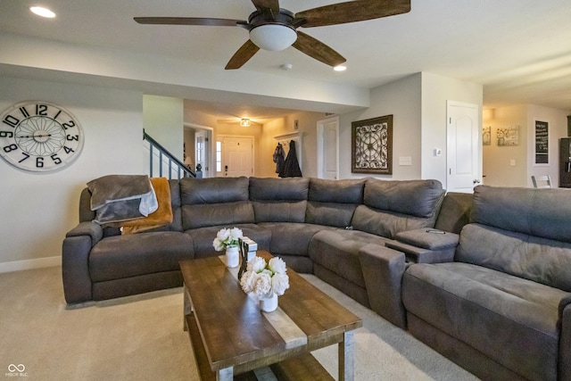 living room with recessed lighting, stairs, baseboards, and light colored carpet