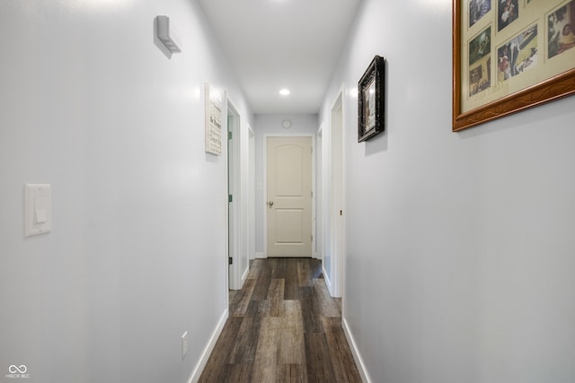 corridor with baseboards, dark wood finished floors, and recessed lighting