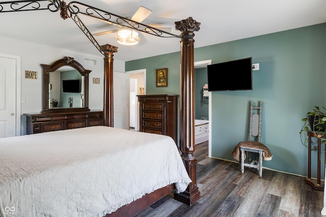 bedroom featuring visible vents, decorative columns, and wood finished floors