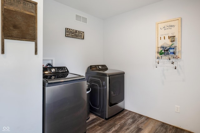 laundry area featuring laundry area, dark wood finished floors, visible vents, and washer and dryer