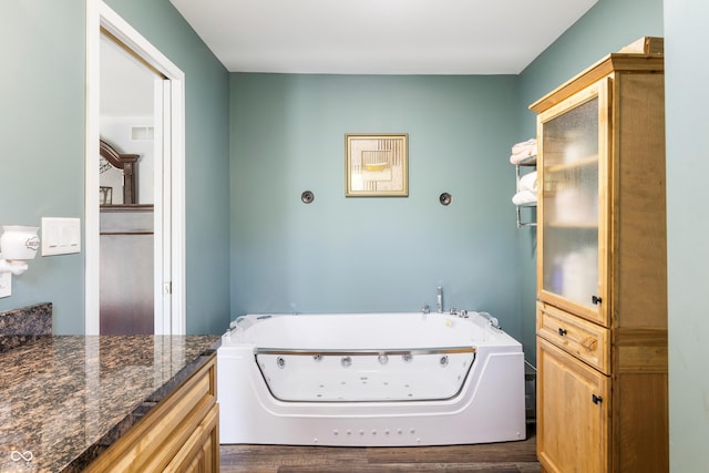 laundry area featuring cabinet space, visible vents, and dark wood-type flooring