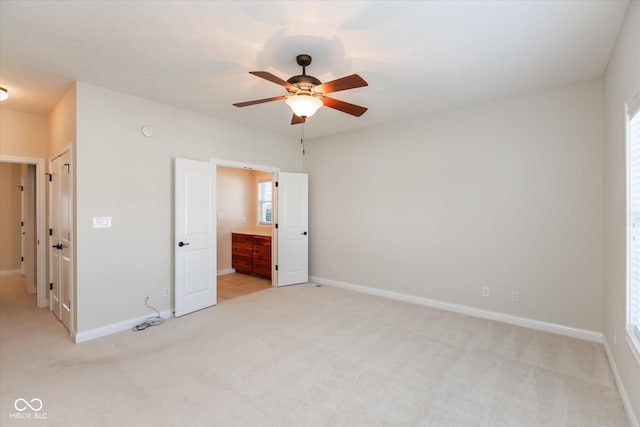 unfurnished bedroom featuring light colored carpet and baseboards