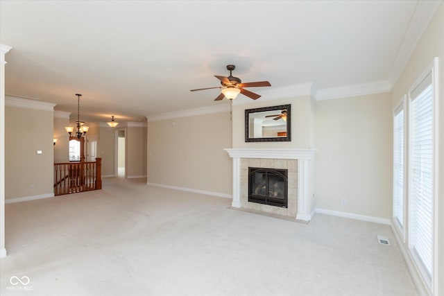 unfurnished living room featuring crown molding, visible vents, a tiled fireplace, light carpet, and baseboards