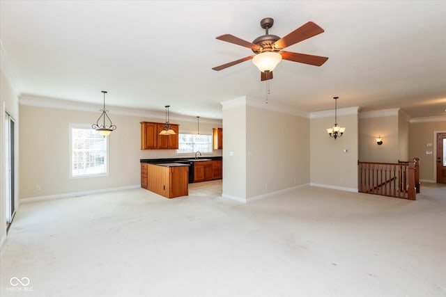 unfurnished living room with ornamental molding, light carpet, and plenty of natural light