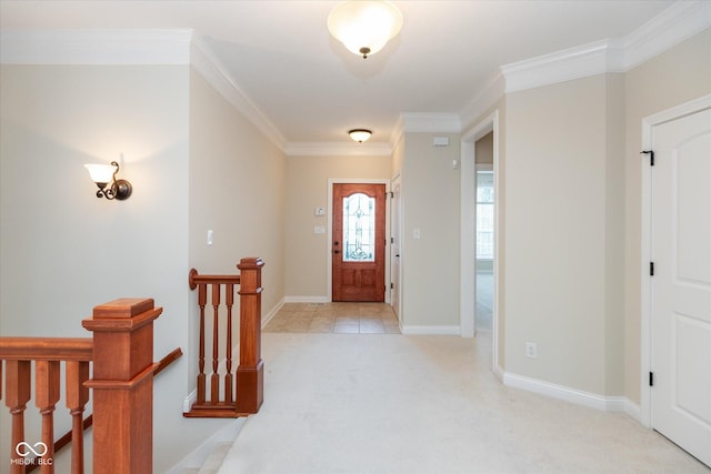 foyer featuring light carpet, ornamental molding, and baseboards