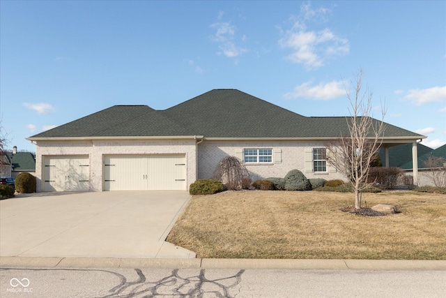 single story home featuring a shingled roof, concrete driveway, an attached garage, a front yard, and brick siding