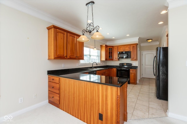 kitchen with brown cabinets, crown molding, a sink, a peninsula, and black appliances