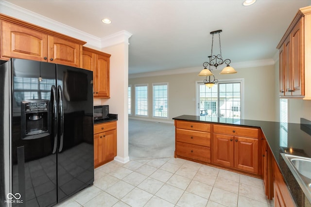 kitchen featuring a peninsula, black appliances, dark countertops, and brown cabinets