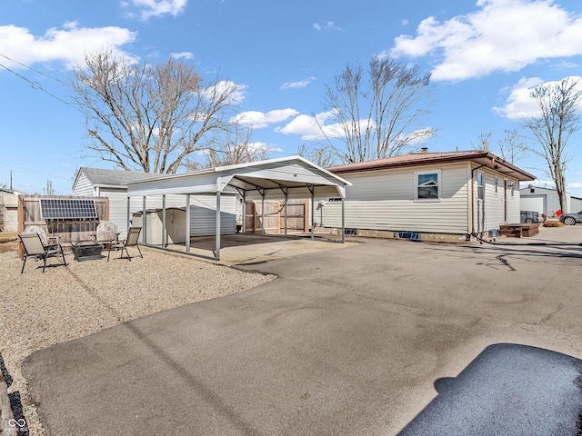 exterior space featuring a carport and fence