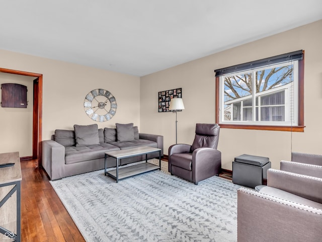 living area featuring baseboards and hardwood / wood-style flooring