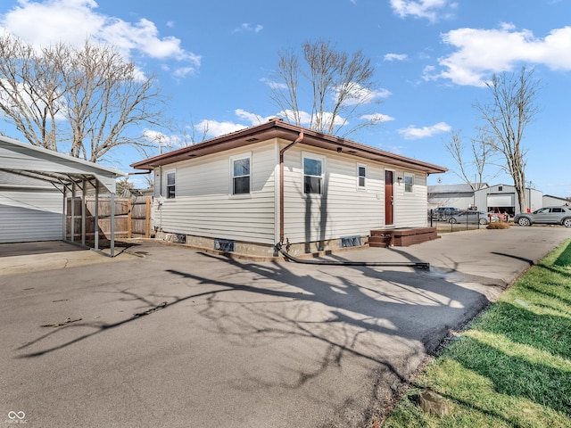 exterior space with driveway and fence