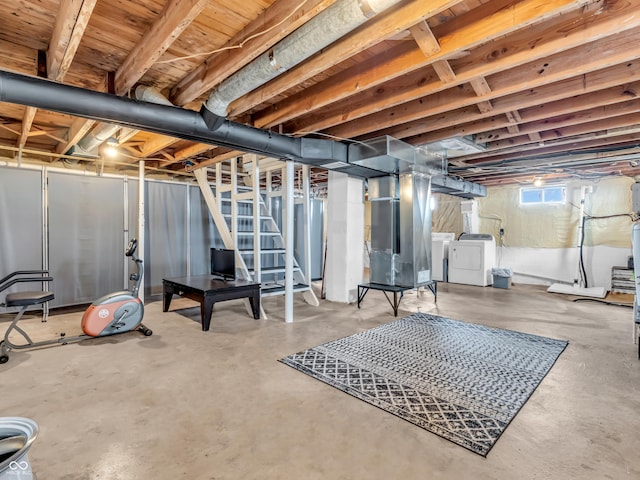 basement with heating unit, stairs, and independent washer and dryer