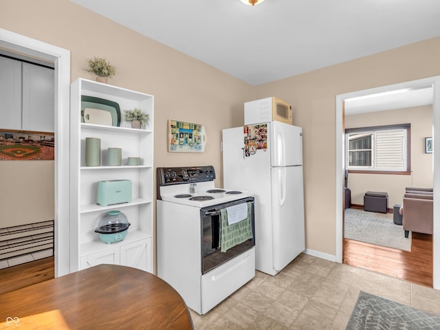 kitchen with white appliances and baseboards