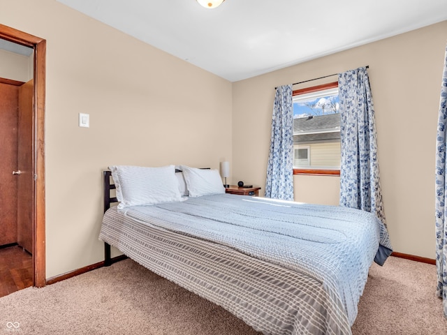 bedroom featuring carpet and baseboards