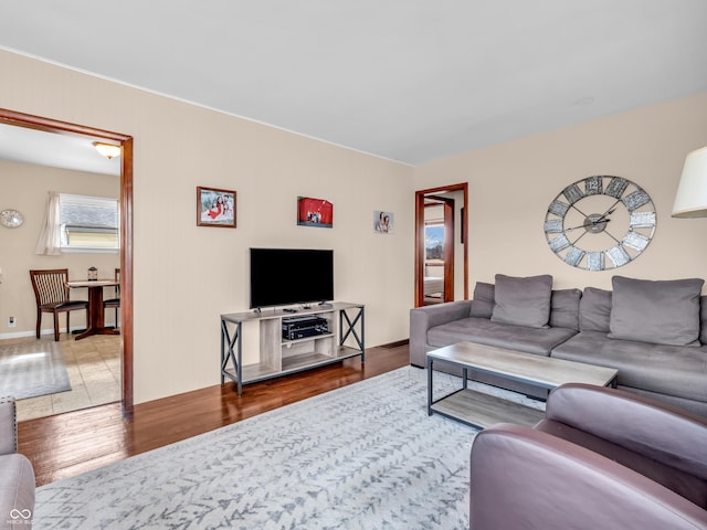 living room with baseboards and wood finished floors