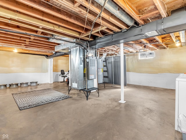 basement with water heater, washer / dryer, and heating unit