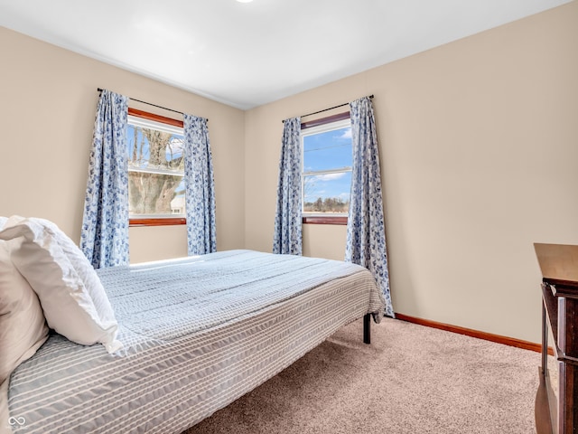 bedroom featuring carpet flooring and baseboards