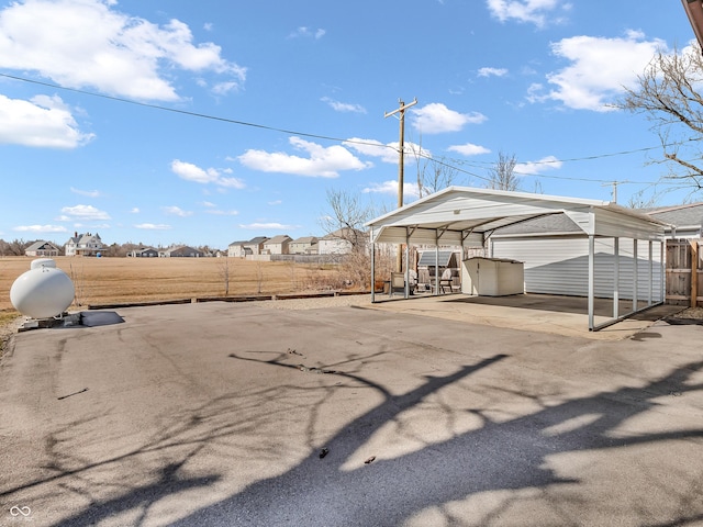 exterior space featuring a carport and fence