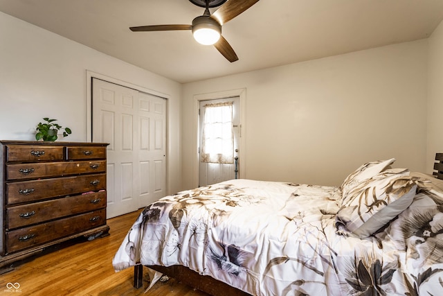 bedroom with a ceiling fan, a closet, and wood finished floors