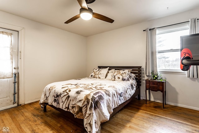 bedroom featuring wood-type flooring, baseboards, and ceiling fan