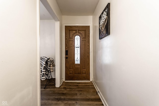 doorway featuring dark wood-style floors and baseboards