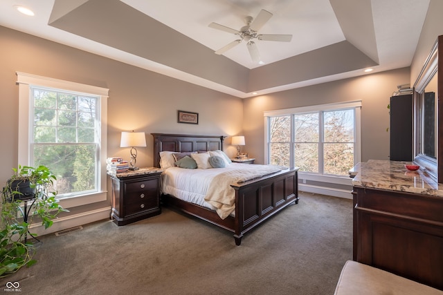 carpeted bedroom with visible vents, recessed lighting, baseboards, and a tray ceiling