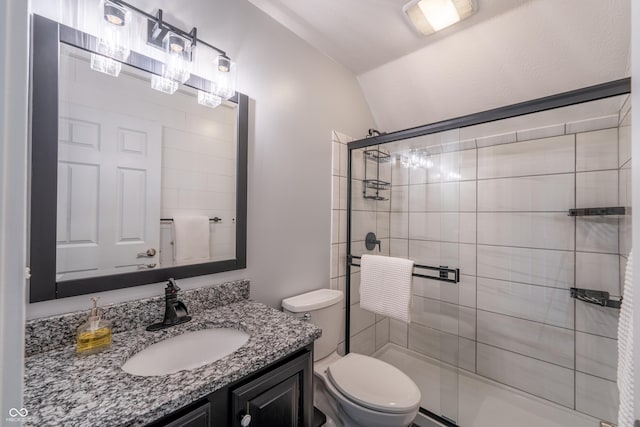 full bathroom with a shower stall, toilet, vanity, and vaulted ceiling