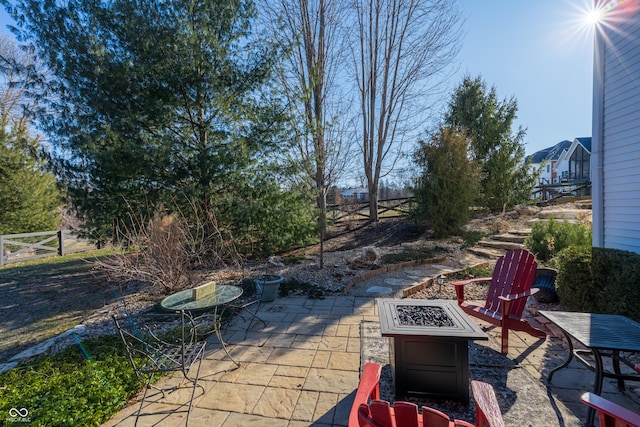 view of patio with a fire pit and fence