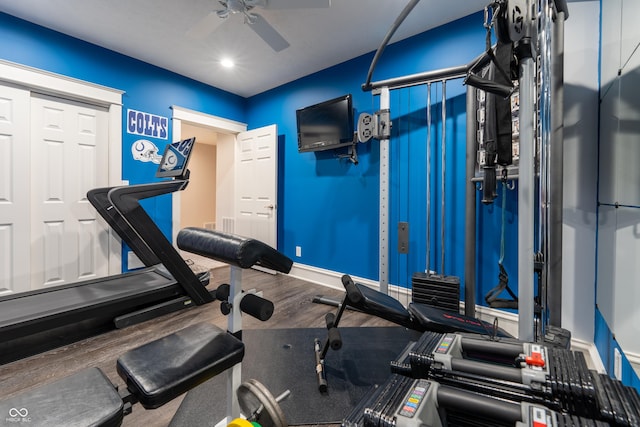 workout room featuring baseboards, wood finished floors, and a ceiling fan