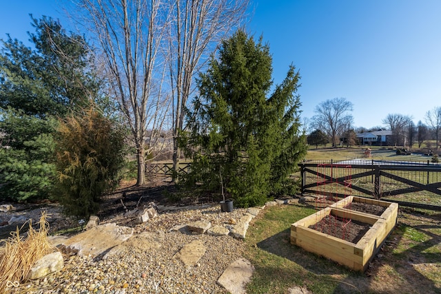 view of gate with a vegetable garden