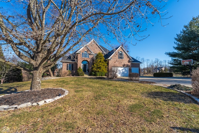 traditional-style house featuring brick siding, driveway, and a front yard