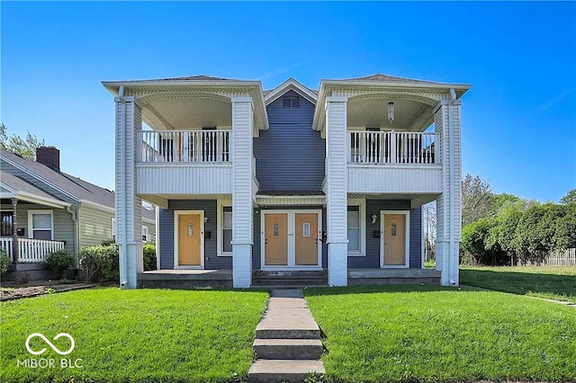 view of front of house with a porch, a front yard, and a balcony