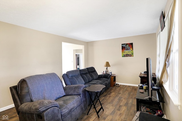 living area featuring dark wood-style floors and baseboards