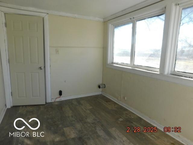 laundry room with baseboards, wood finished floors, and a healthy amount of sunlight