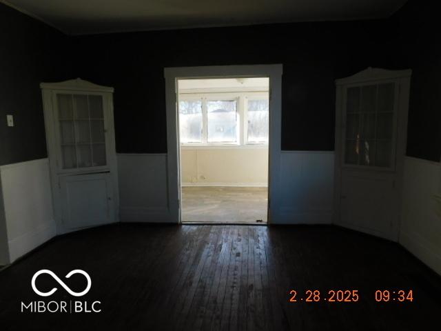 unfurnished room with wood finished floors